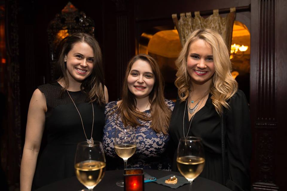 Erin enjoys some vino with members of her social media squad at a company holiday party.